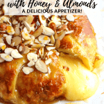 Brie wrapped in puff pastry with honey & almonds and baked until golden and cheese is melted.