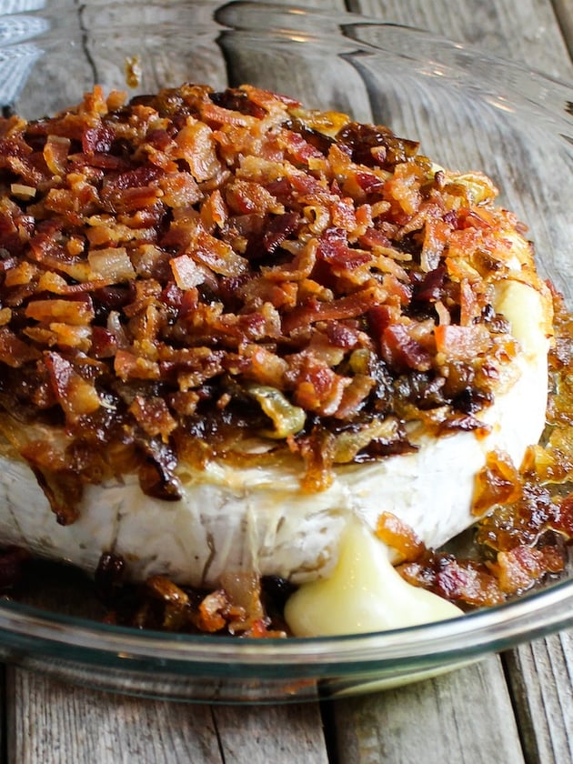 Brie baked and covered in Caramelized Onions and Bacon with cheese running out