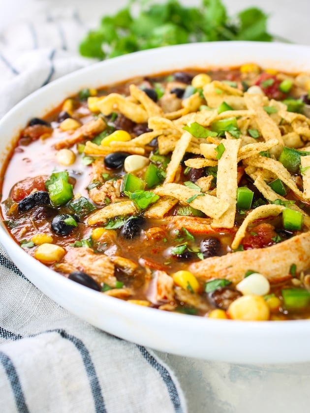 A bowl of the chicken tortilla soup recipe that is ready to eat.