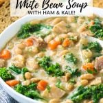 A bowl of Instant Pot White Bean Soup with chopped ham steak and fresh kale.