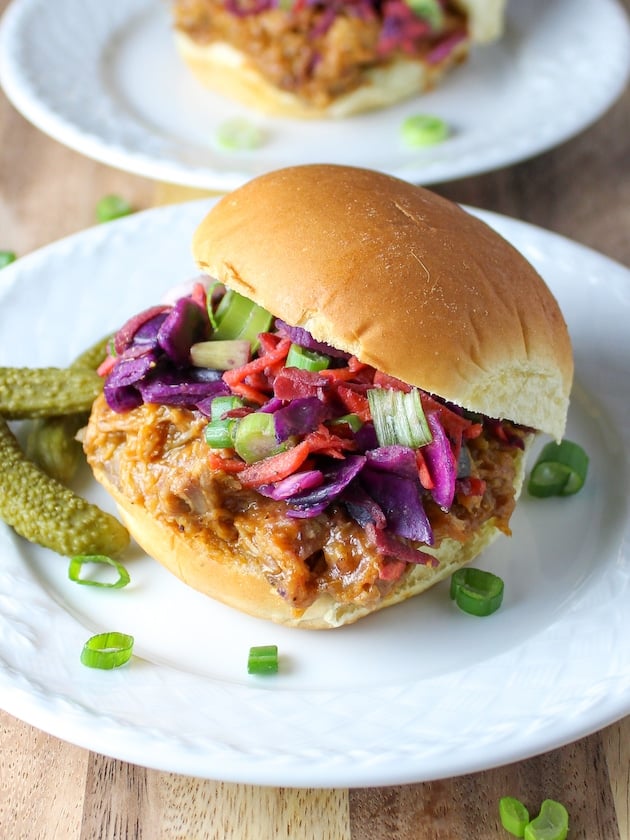 Pulled pork sandwhiches with coleslaw and pickles.