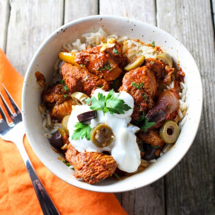 A bowl with cooked harissa marinaded chicken and veggies.