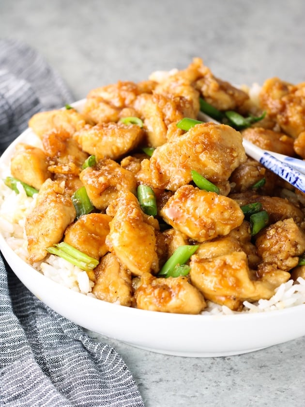 Mongolian chicken in a bowl over jasmine rice.