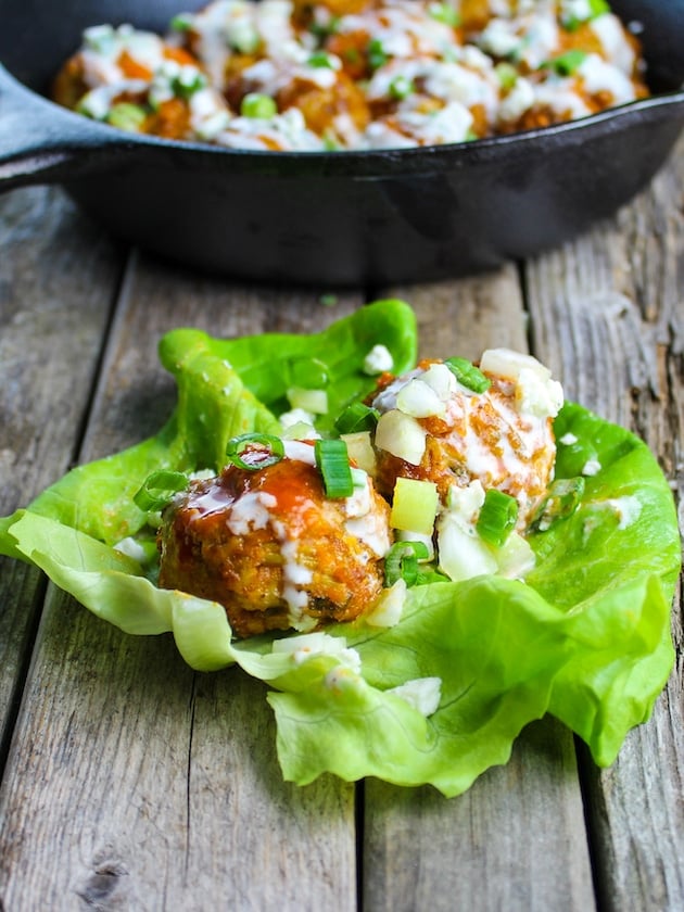 A lettuce wrap with meatballs tossed in hot sauce and drizzled with blue cheese sauce.