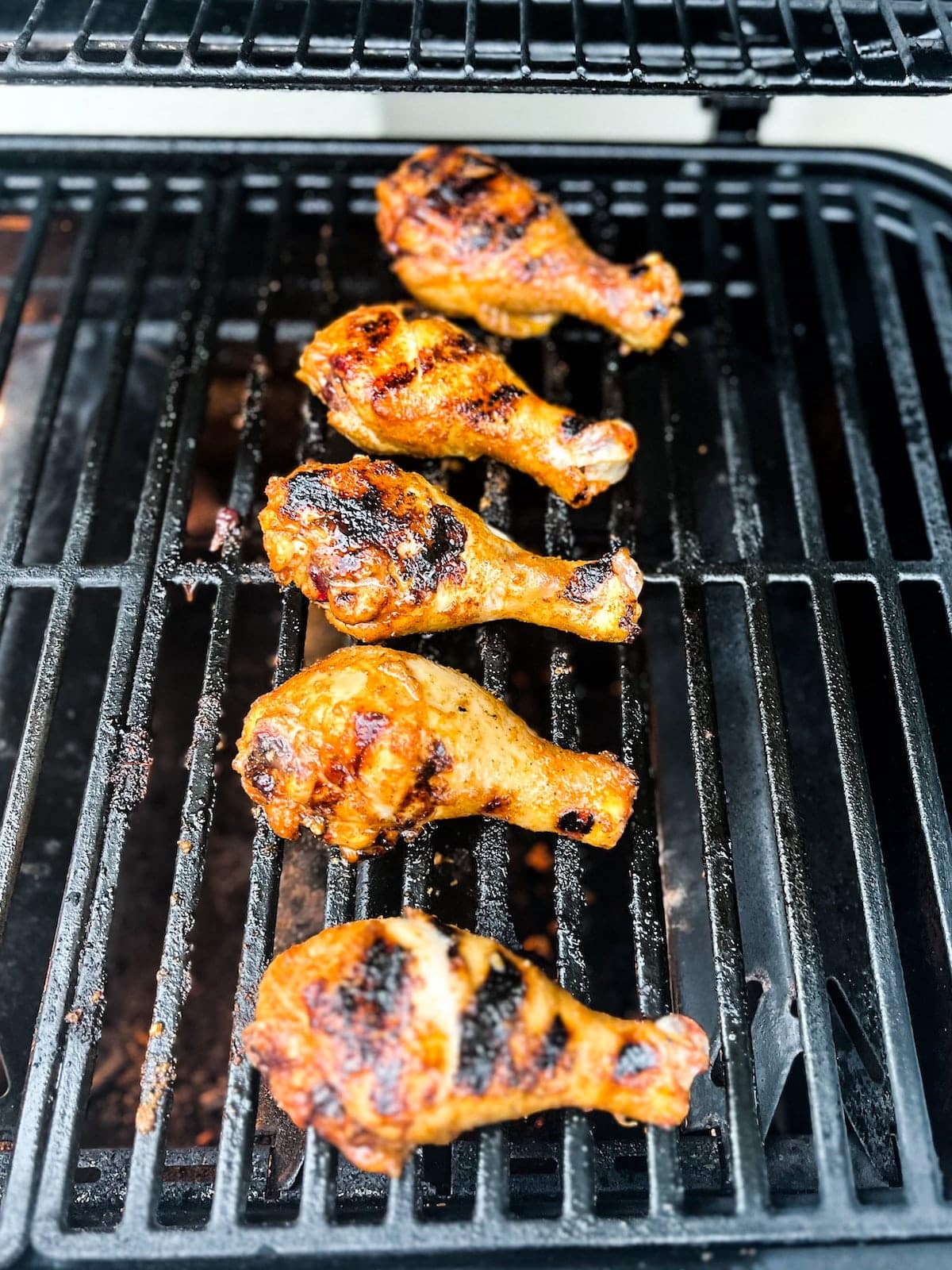 BBQ chicken legs cooking on the grill..