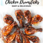 A Pinterest pin of a platter with grilled bbq chicken drumsticks.