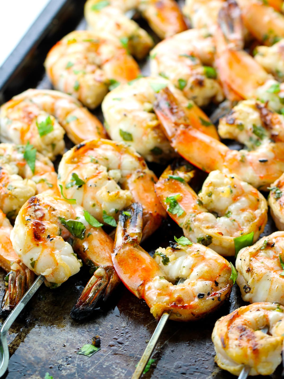 A close-up of grilled shrimp on skewers.