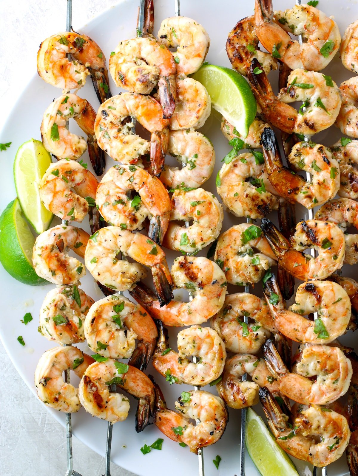 Skewers of grilled shrimp on a platter.