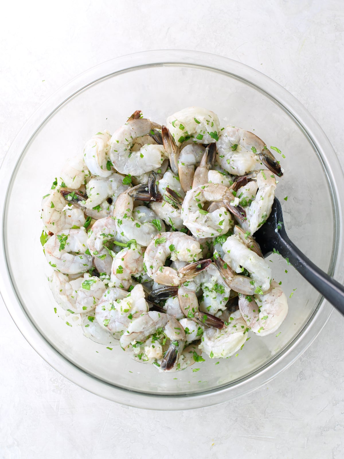 A bowl of shrimp in cilantro lime marinade.