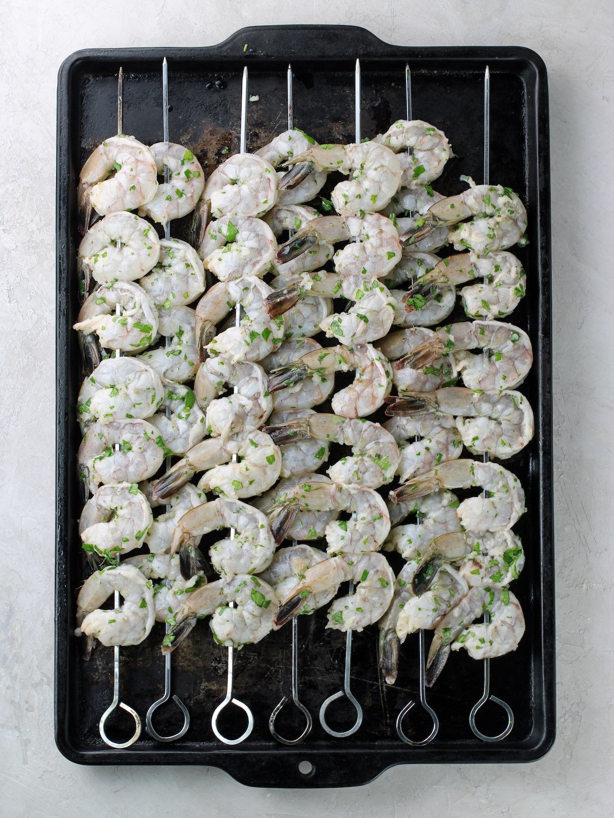 7 skewers of on a baking sheet.