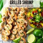 A Pinterest Pin with marinated cilantro lime shrimp on skewers with pineapple salsa.