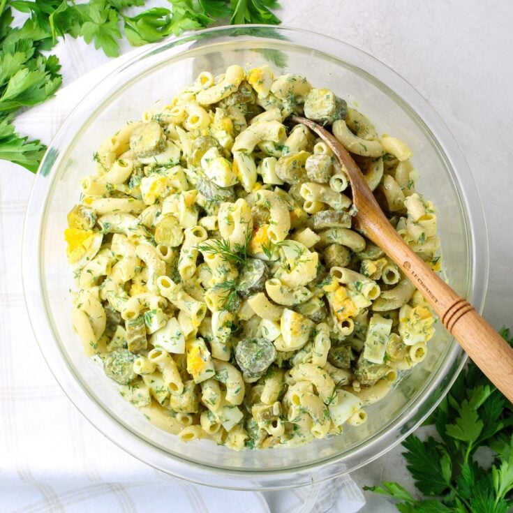 A bowl of Macaroni Pasta salad with pickles.