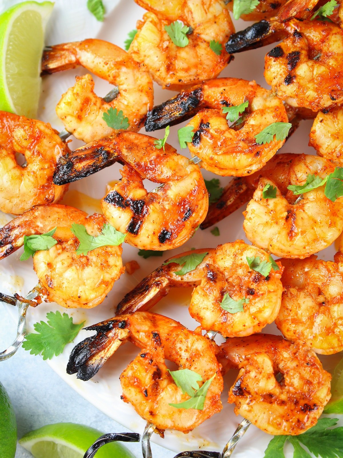 A close-up photo of cooked shrimp on skewers.
