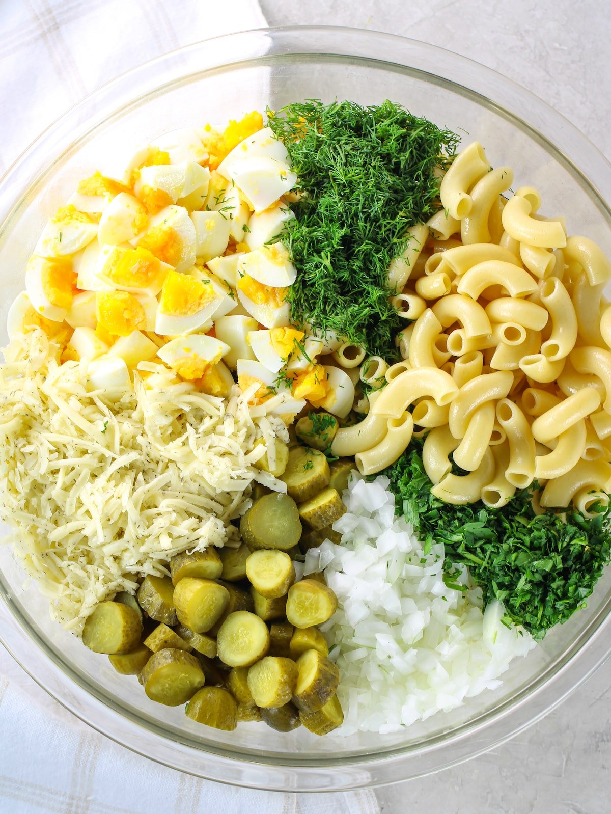 Ingredients for Macaroni salad in a bowl before combining.