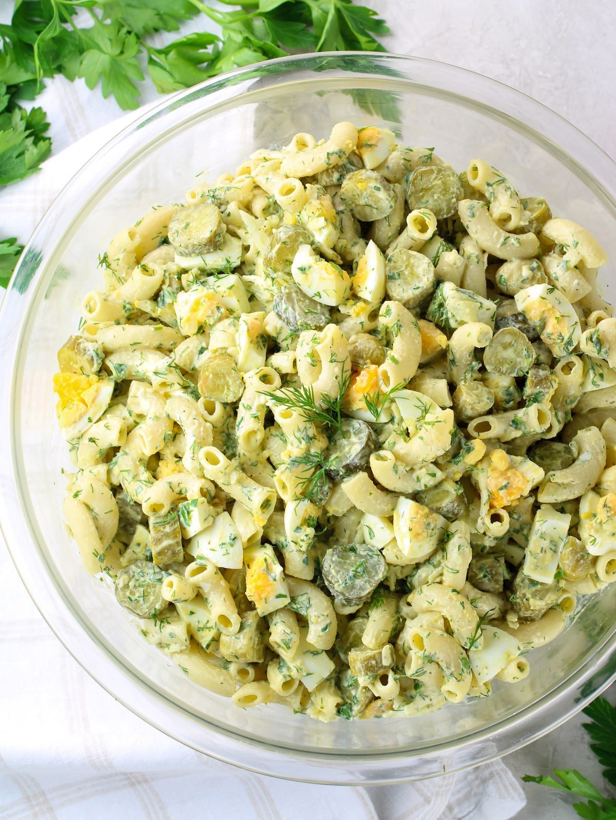 A bowl of Macaroni Pasta salad with dill.