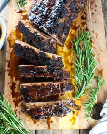 Balsamic ribs on a cutting board sliced up.