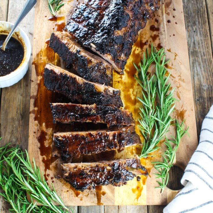 Balsamic ribs on a cutting board sliced up.