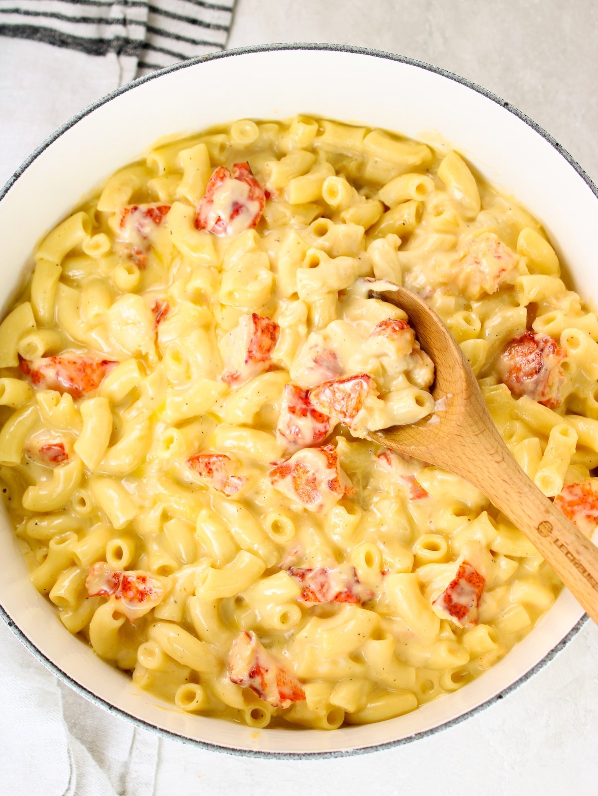 A large pot of macaroni and cheese with lobster mixed in.