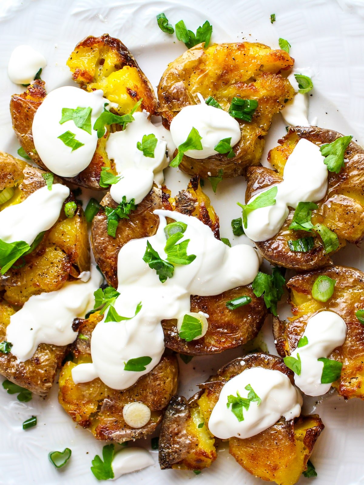 Sour Cream and Onion Smashed Potatoes on a plate.