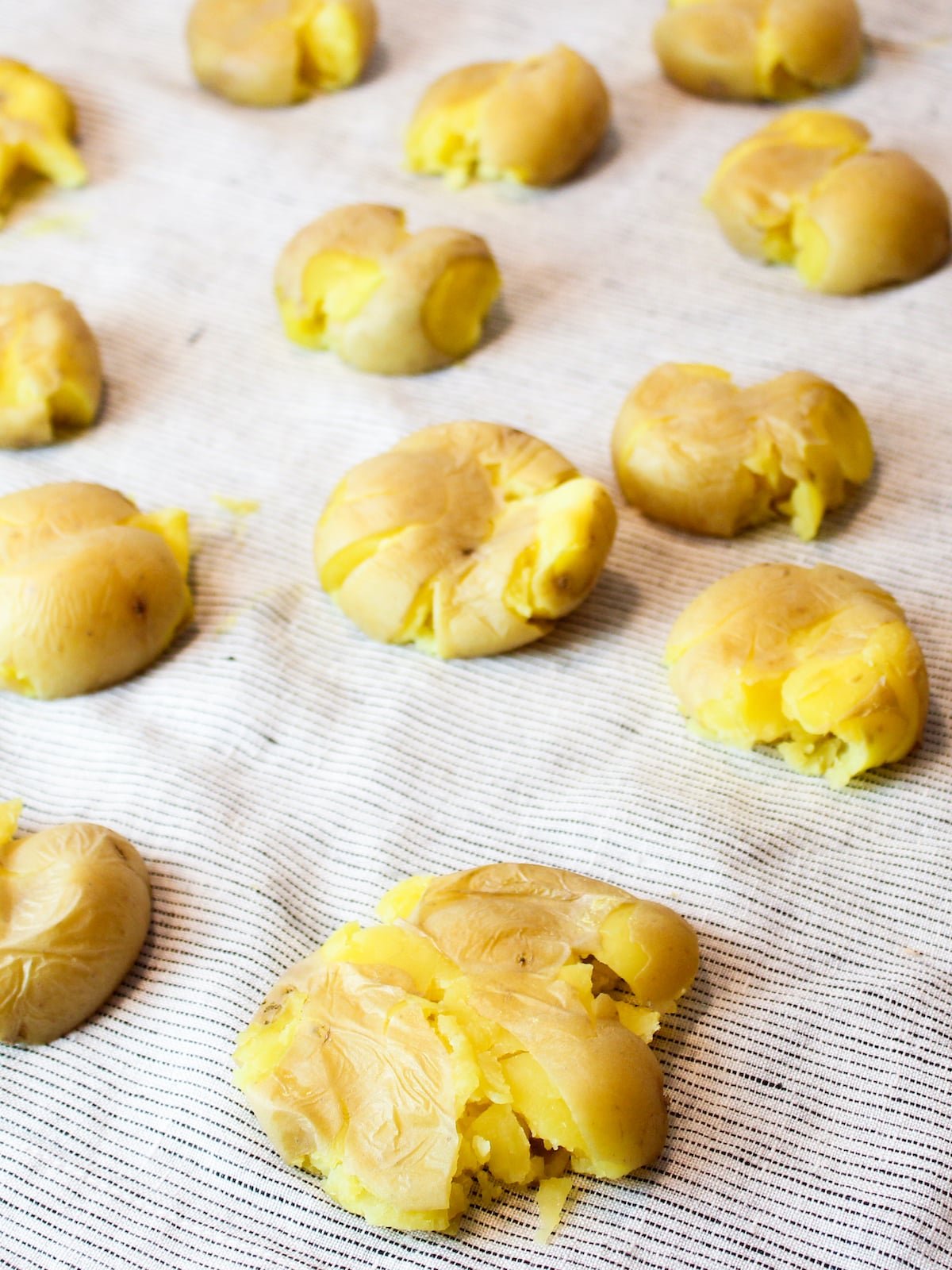 Baby Yukon gold potatoes smashed on a napkin.