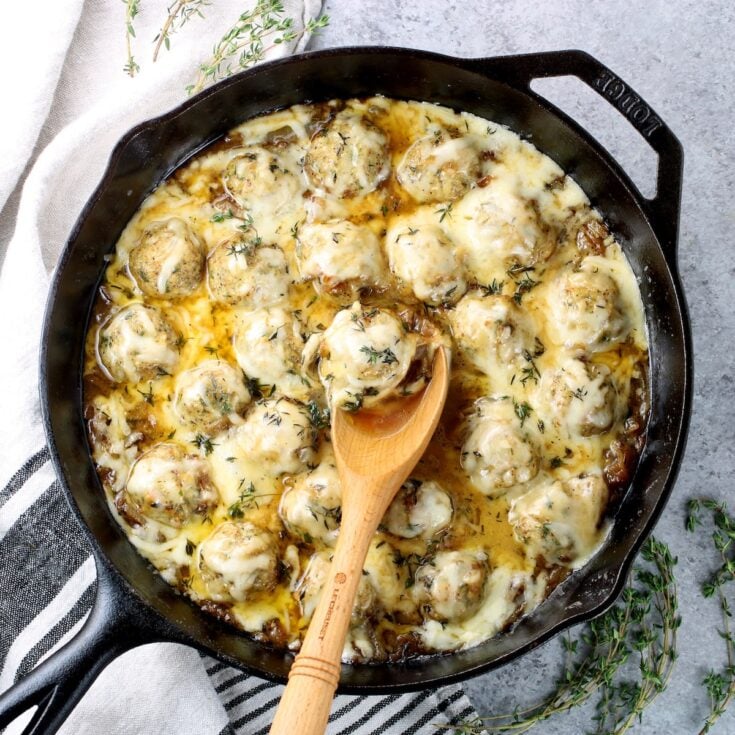 French Onion Chicken Meatballs in a cast-iron skillet.