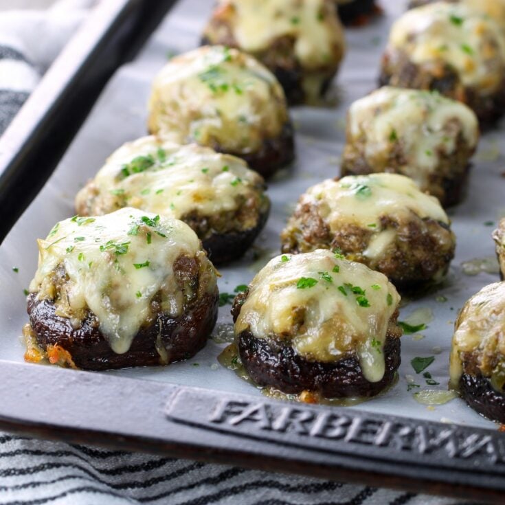 Philly Cheesesteak Stuffed Mushrooms cooked on a baking sheet.
