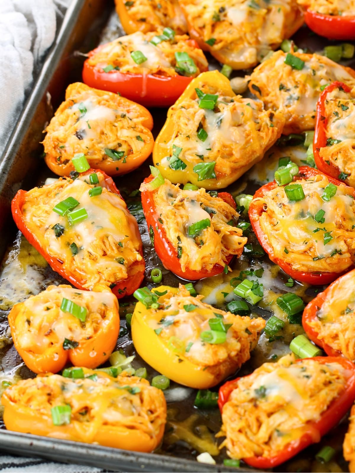 Appetizer recipes - Buffalo Chicken Baby Bell Peppers on a baking sheet.