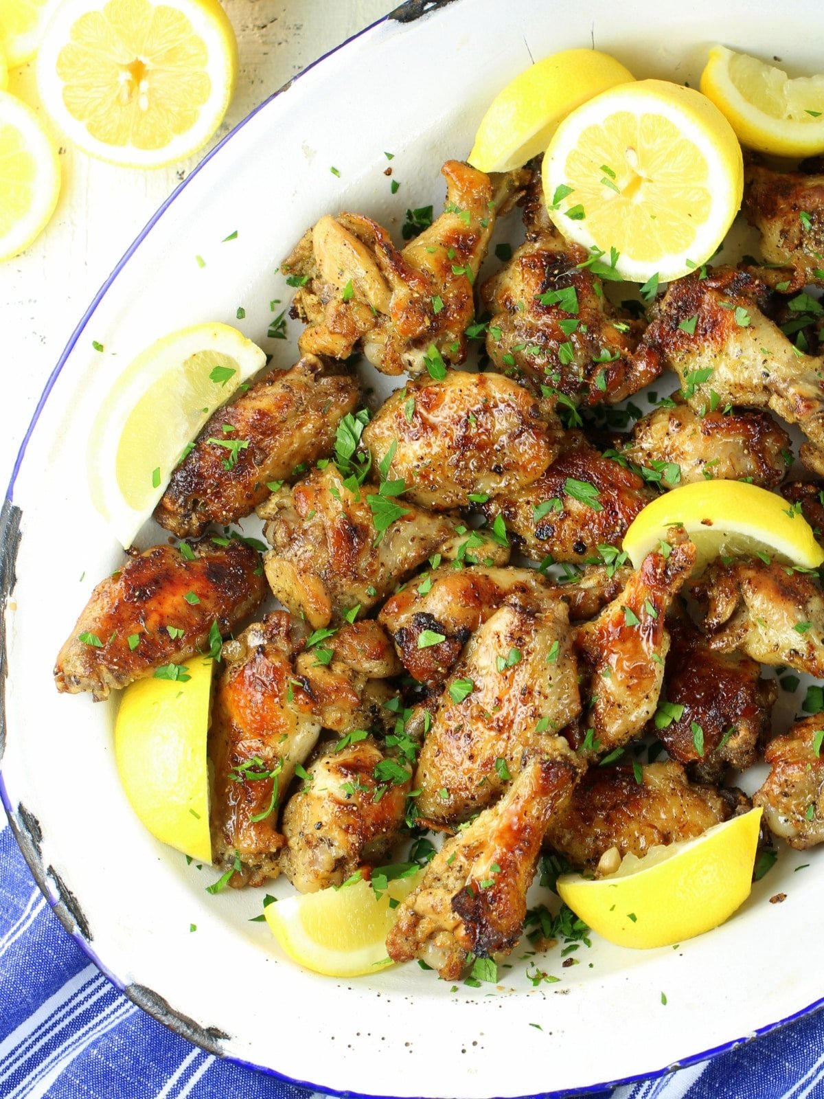 Easy appetizers - Lemon Pepper Wings with lemon wedges on a tray.