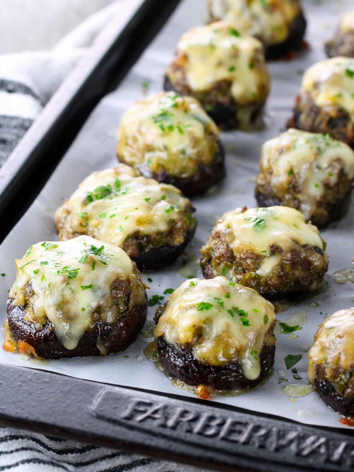 Appetizer recipes - Philly Cheesesteak Stuffed Mushrooms on a baking sheet.