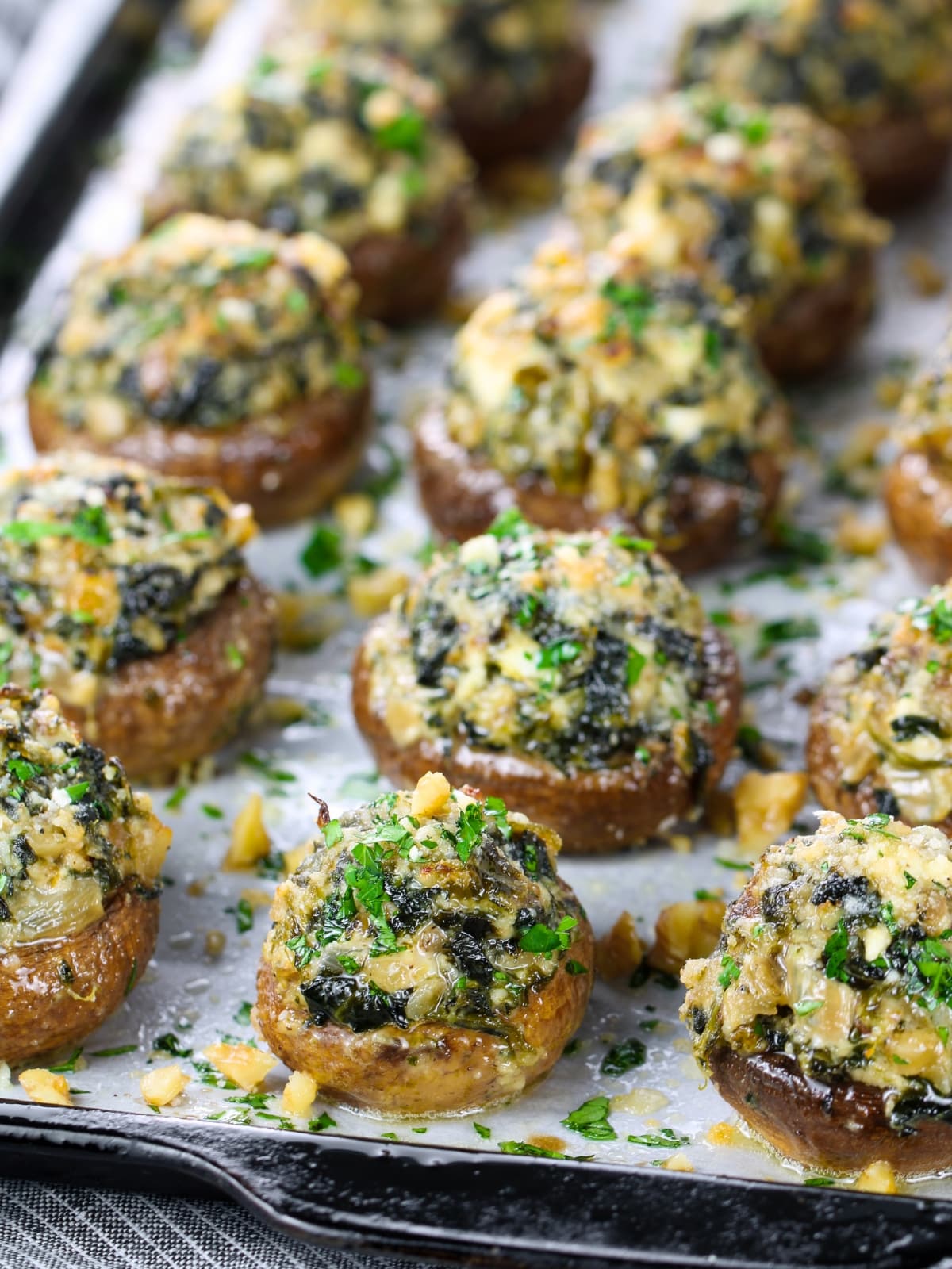 Appetizer recipes - Stuffed Mushrooms with Spinach, Feta And Walnuts on a baking sheet.