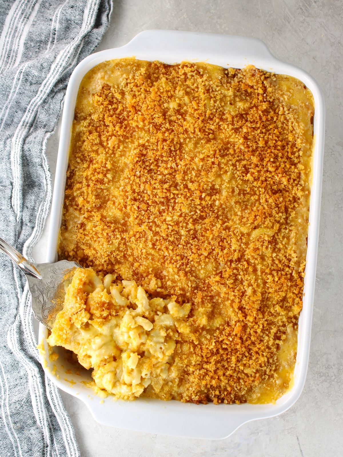 A 9x13 baking dish with baked macaroni and cheese.