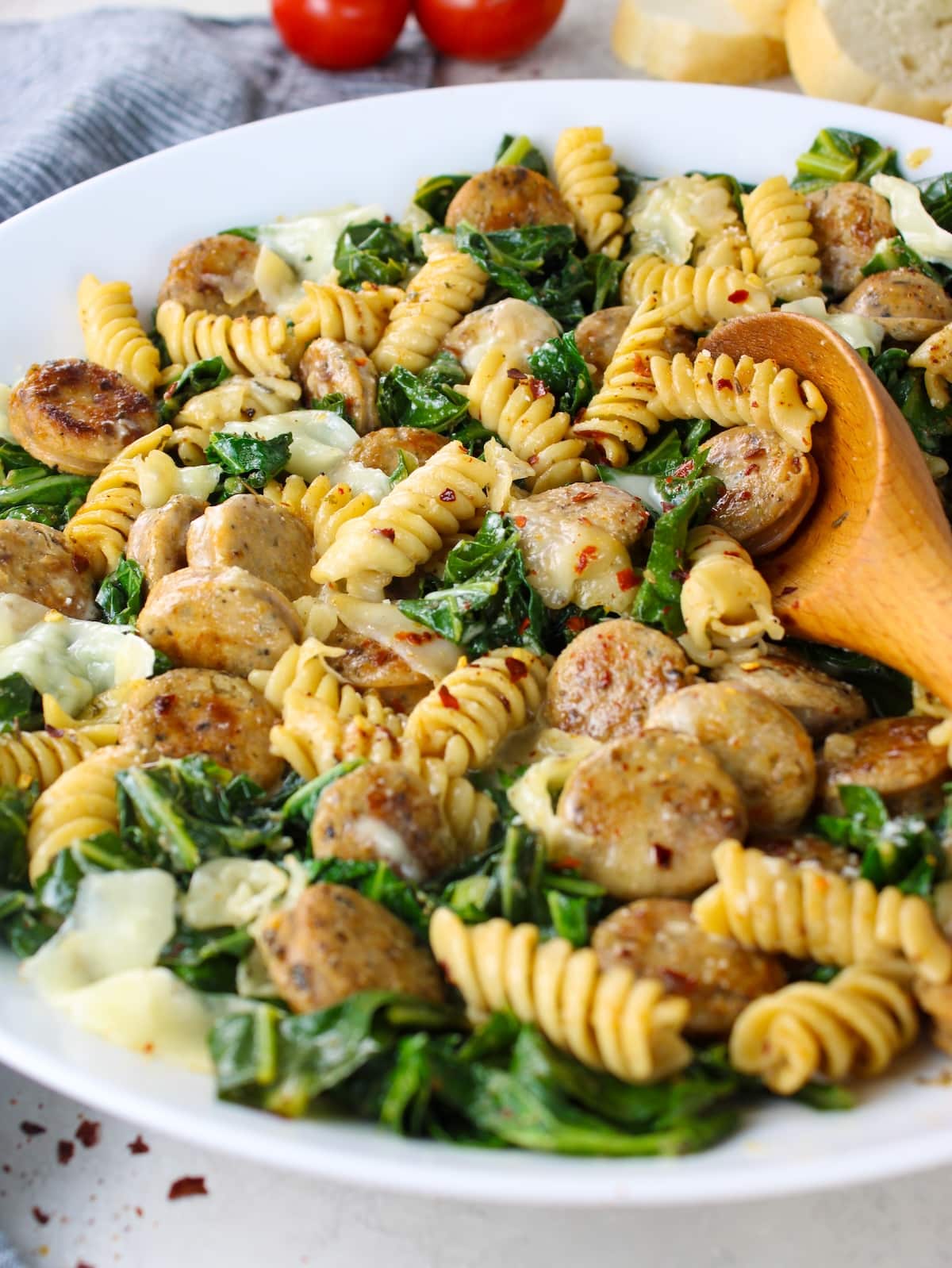 A plate of Italian Herb & Rotini Collard Greens with Chicken Sausage.