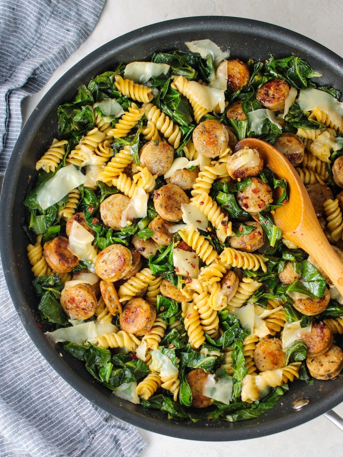 A skillet with Italian Herb & Rotini Collard with Chicken Sausage.