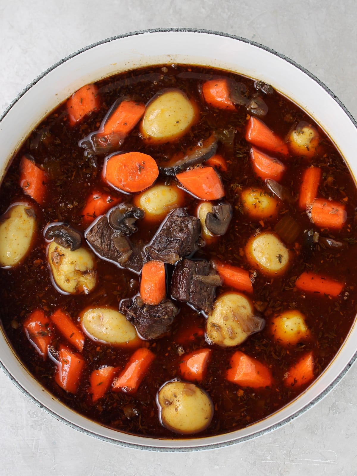 Carrots and potatoes are added to beef stew.