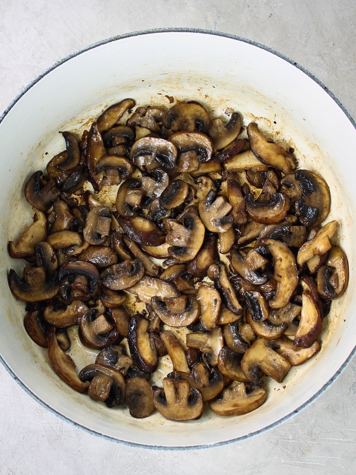 Mushrooms sautéing in a pot.