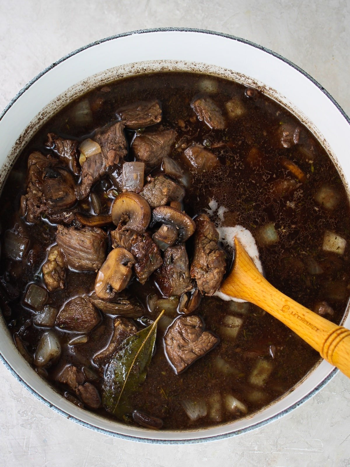 Wine, beef stock added to veggies.