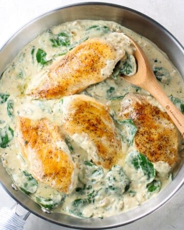 A skillet with cooked Chicken Florentine.