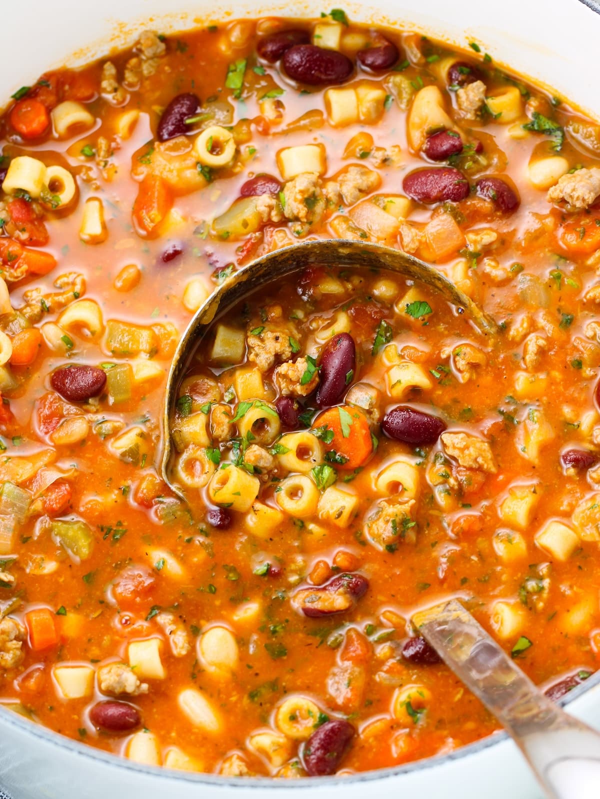 A Dutch oven of Italian soup with Pasta and Beans.
