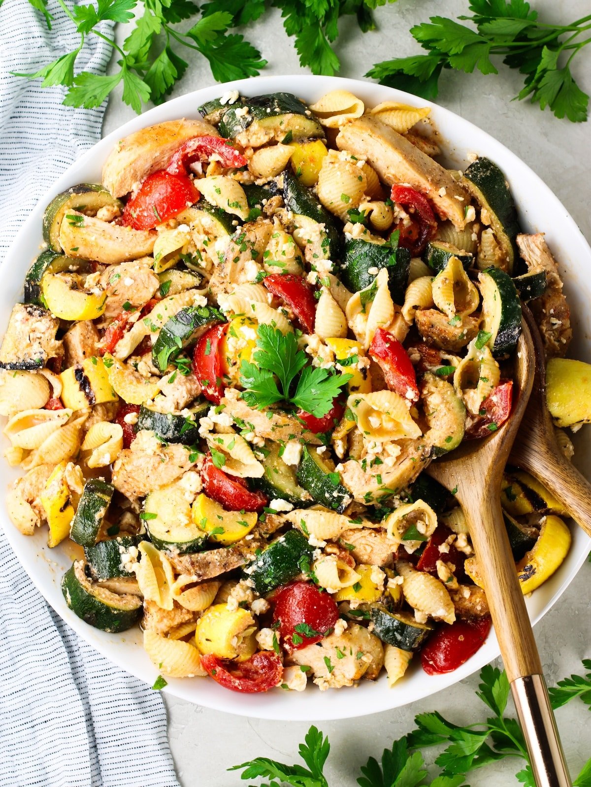 Grilled Chicken and Squash with Tomato Feta Pasta on a platter.