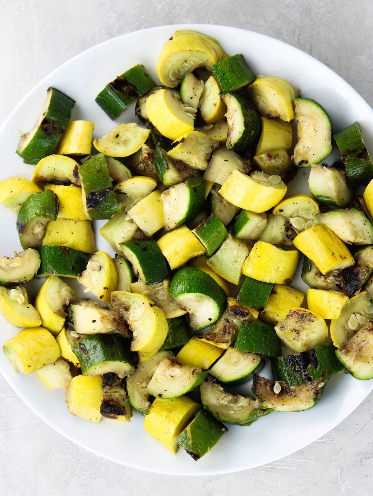 Grilled summer squash and zucchini cut up.