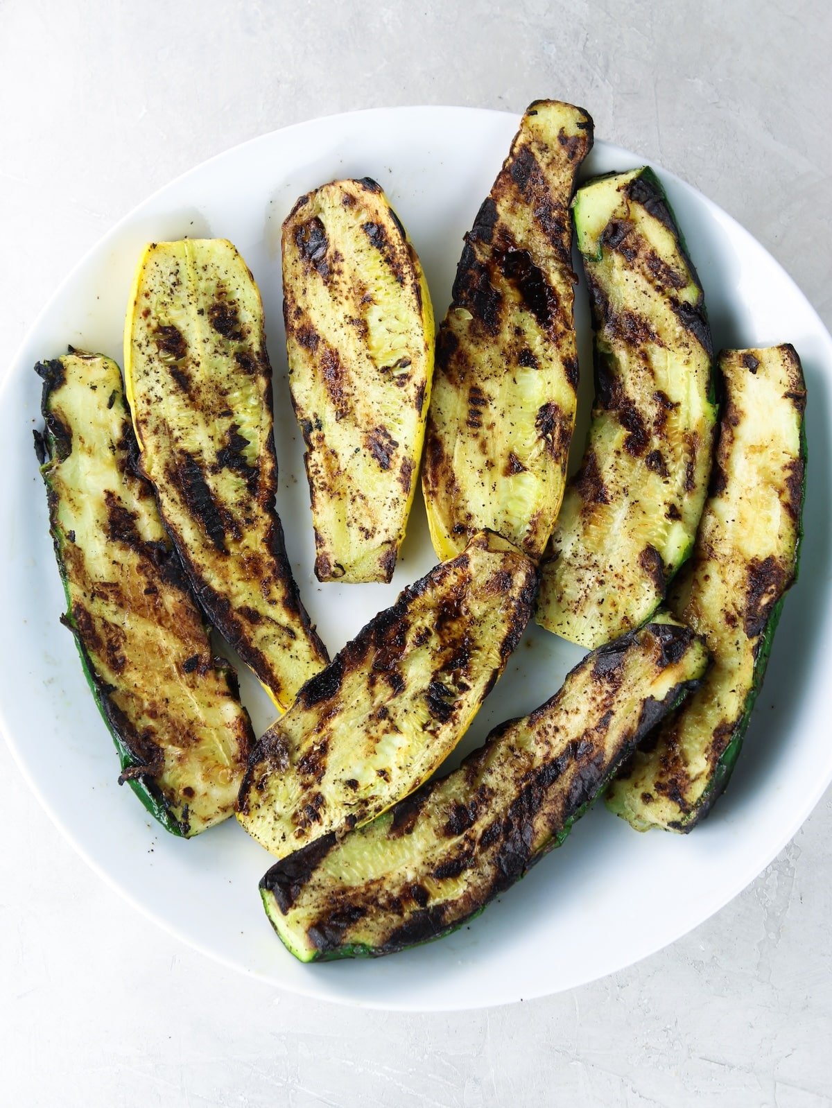 Zucchini and squash grilled on a plate.