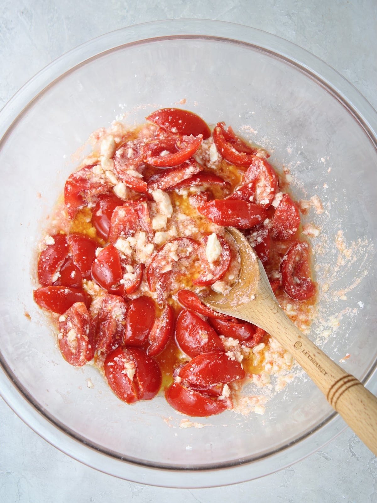 Cut up tomatoes sprinkled with salt and crumbled feta in a large bowl.