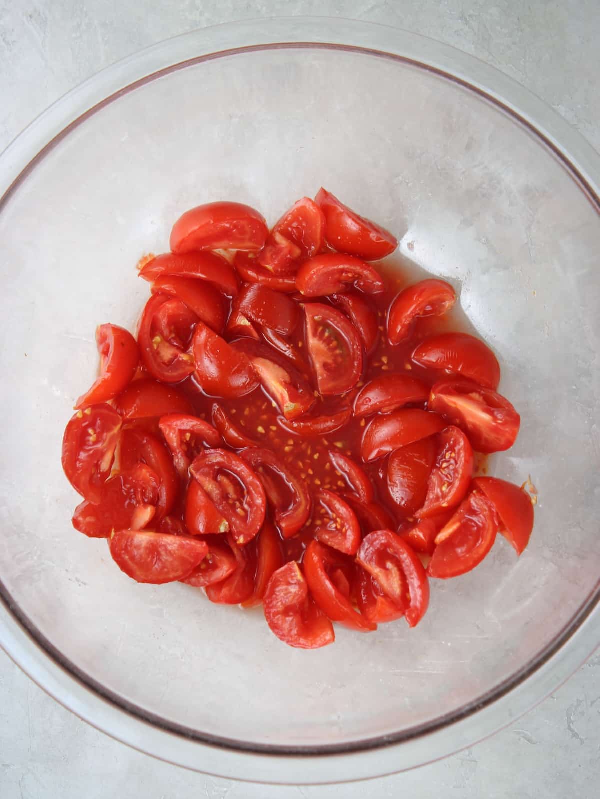 Cut up tomatoes sprinkled with salt in a large bowl.
