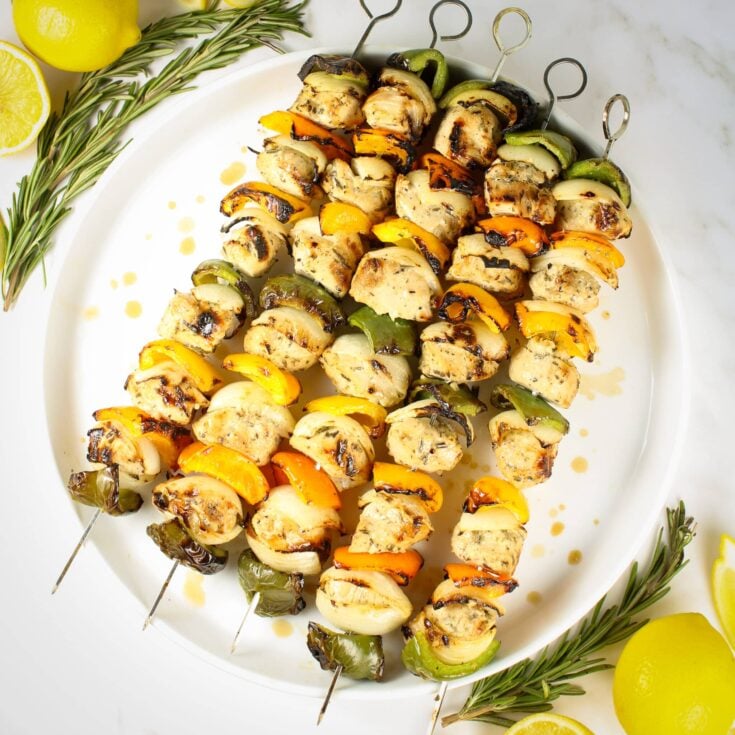 A 1200x1200 photo of skewers of Grilled Rosemary Lemon Chicken Kabob on a platter
