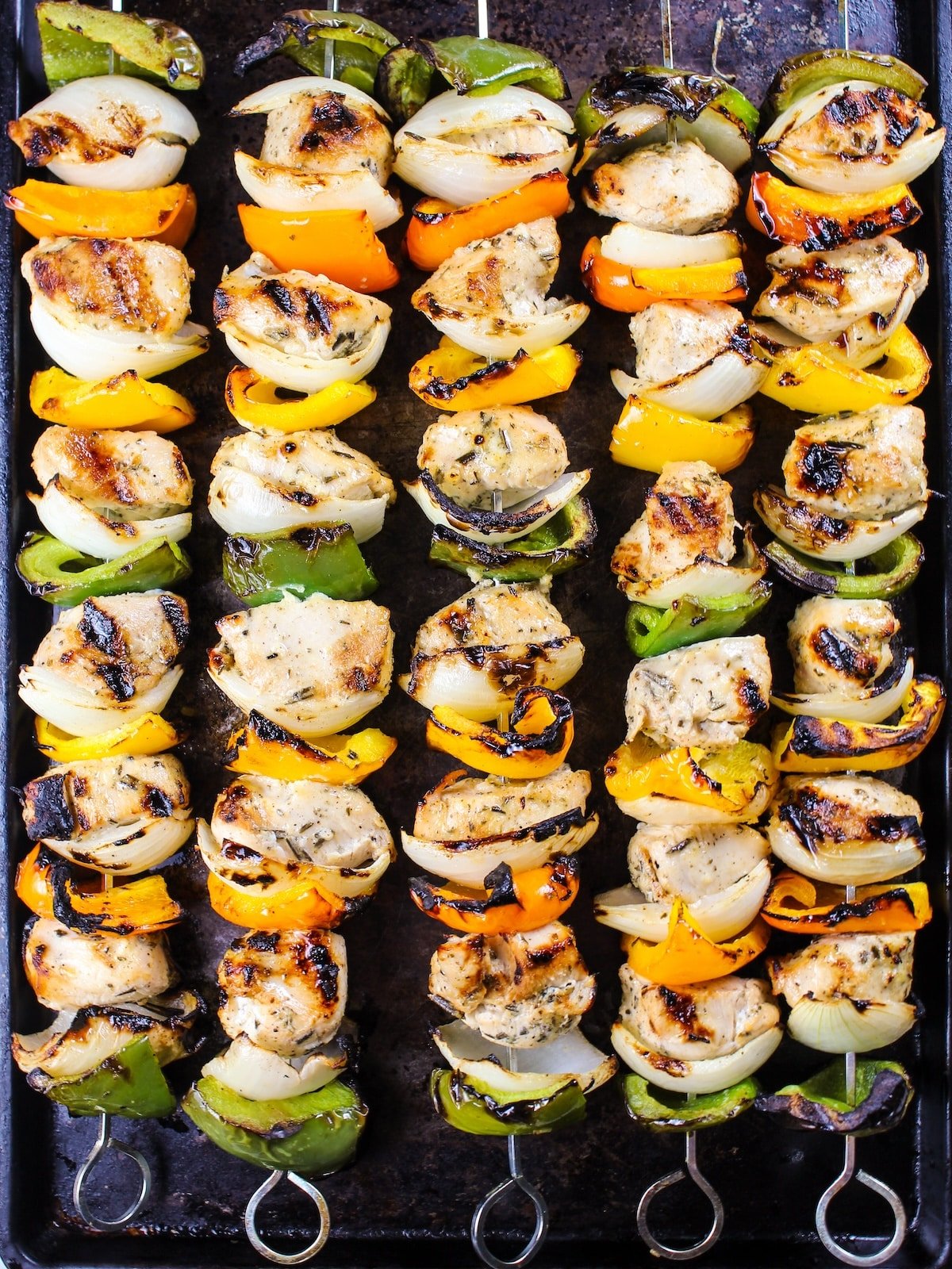 Grilled kabobs on a baking sheet.