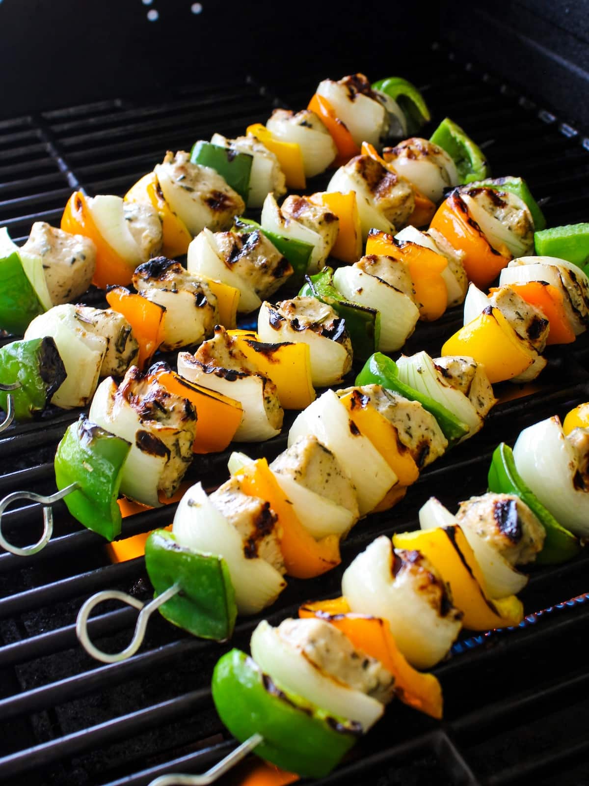 Chicken skewers being grilled for the chicken kabob recipe.