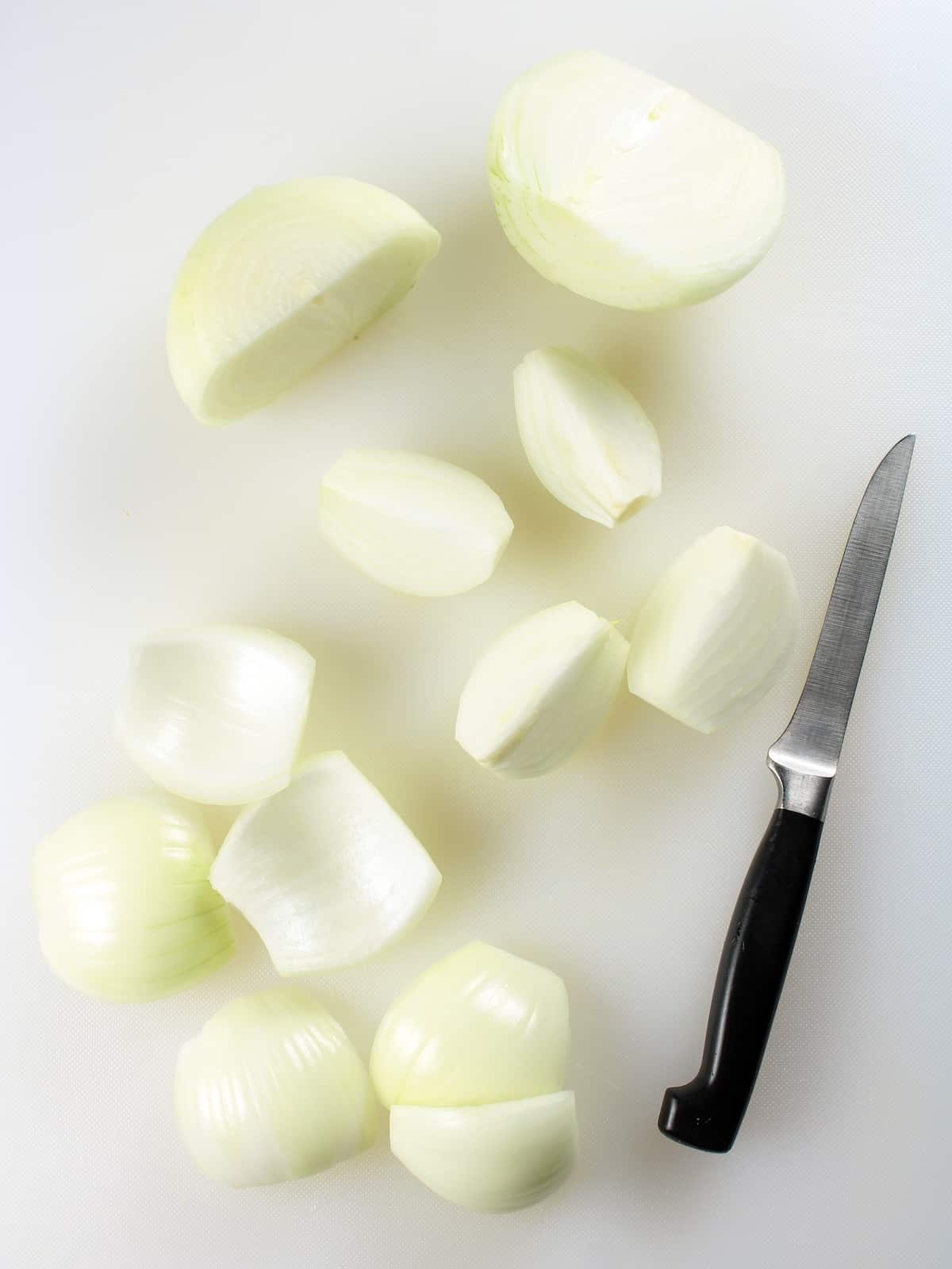 Onions being chopped on a cutting board.