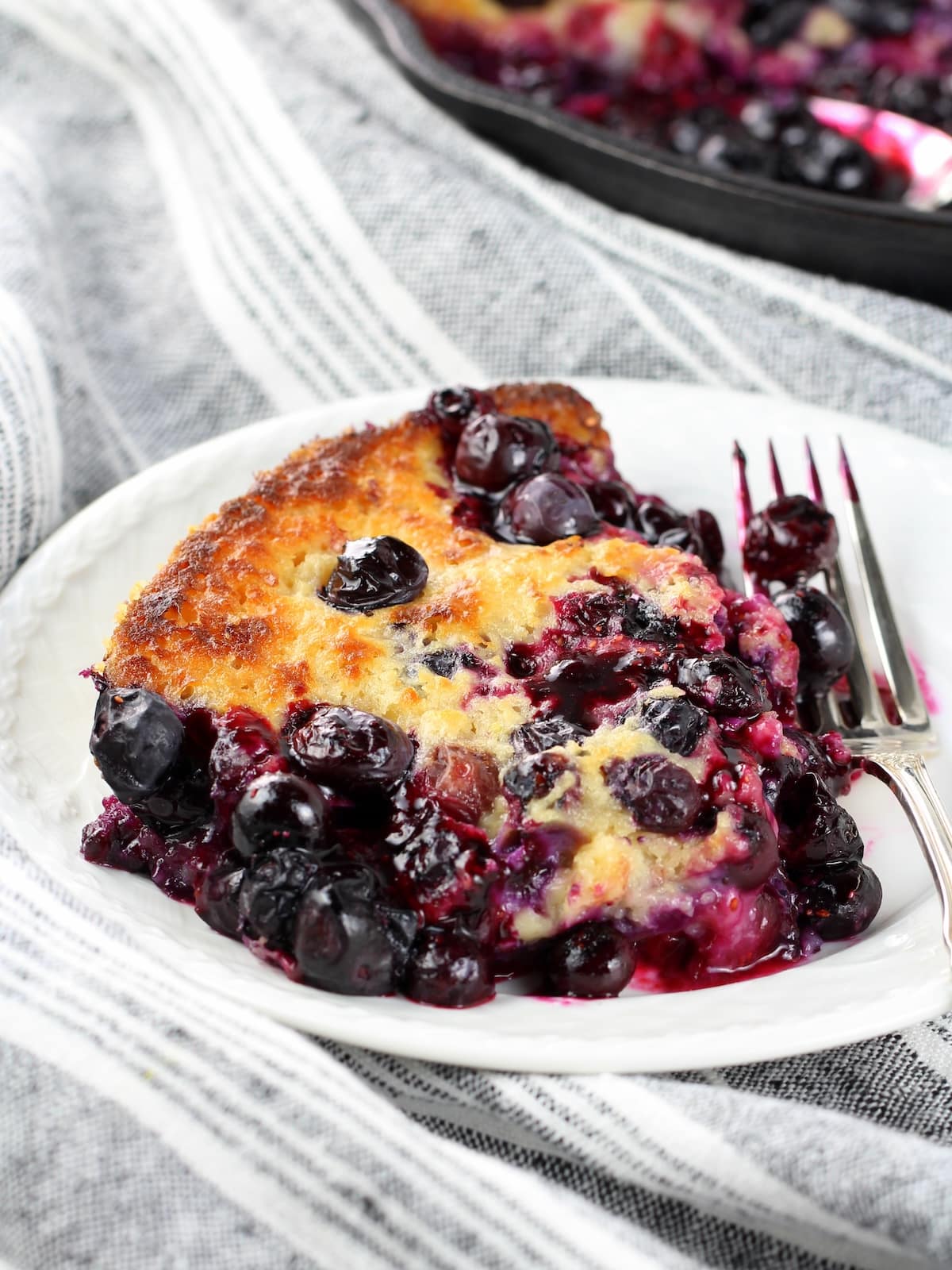 A piece of baked blueberries and batter.