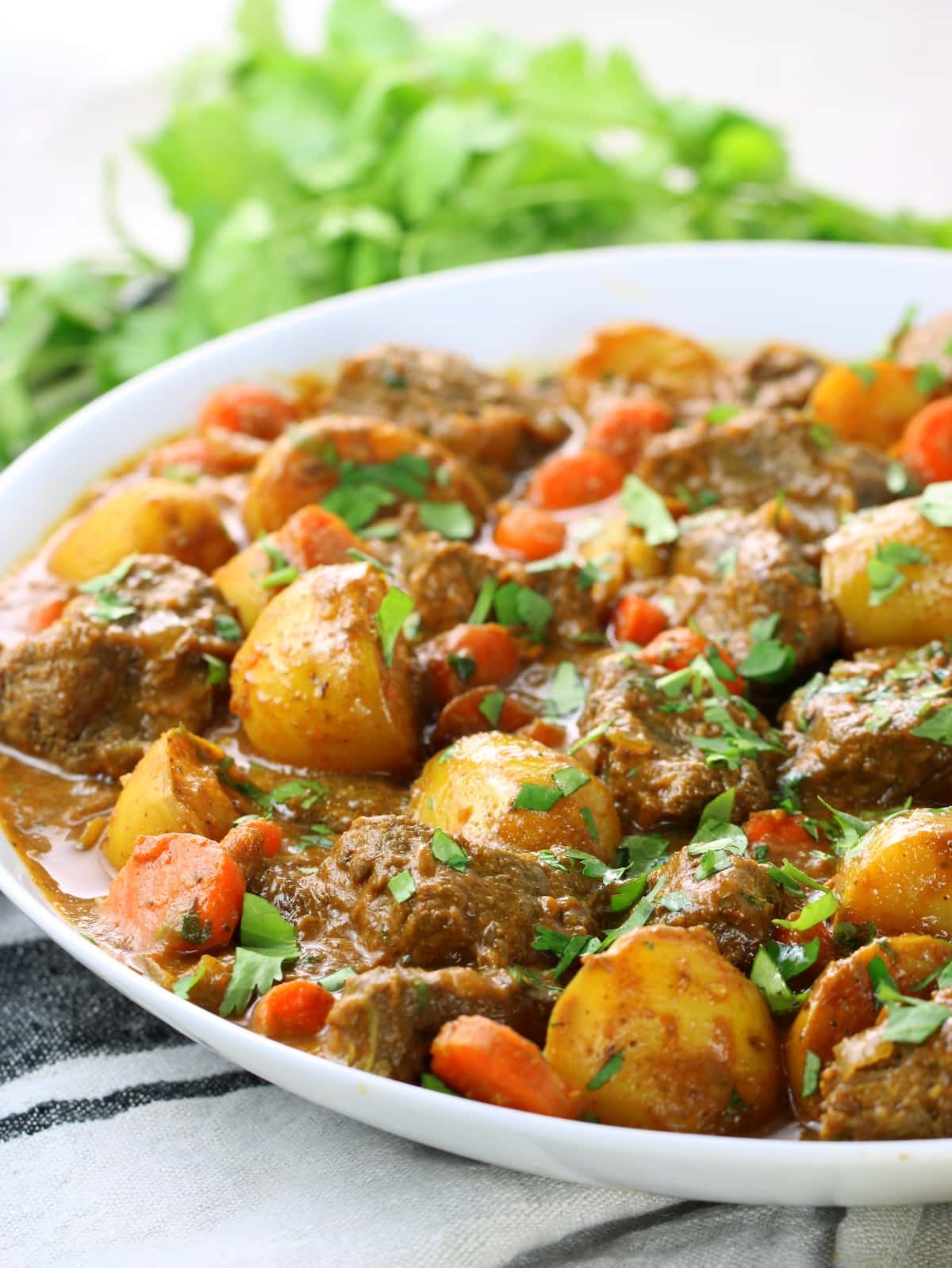 An eye level photo of this beef curry recipe in a bowl.