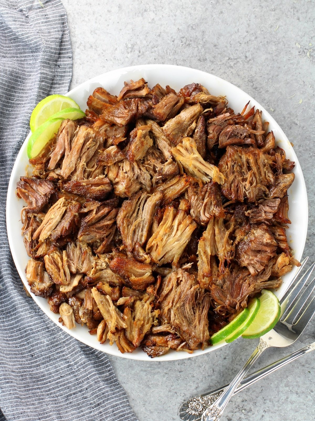 A plate of the meat cooked and pulled.